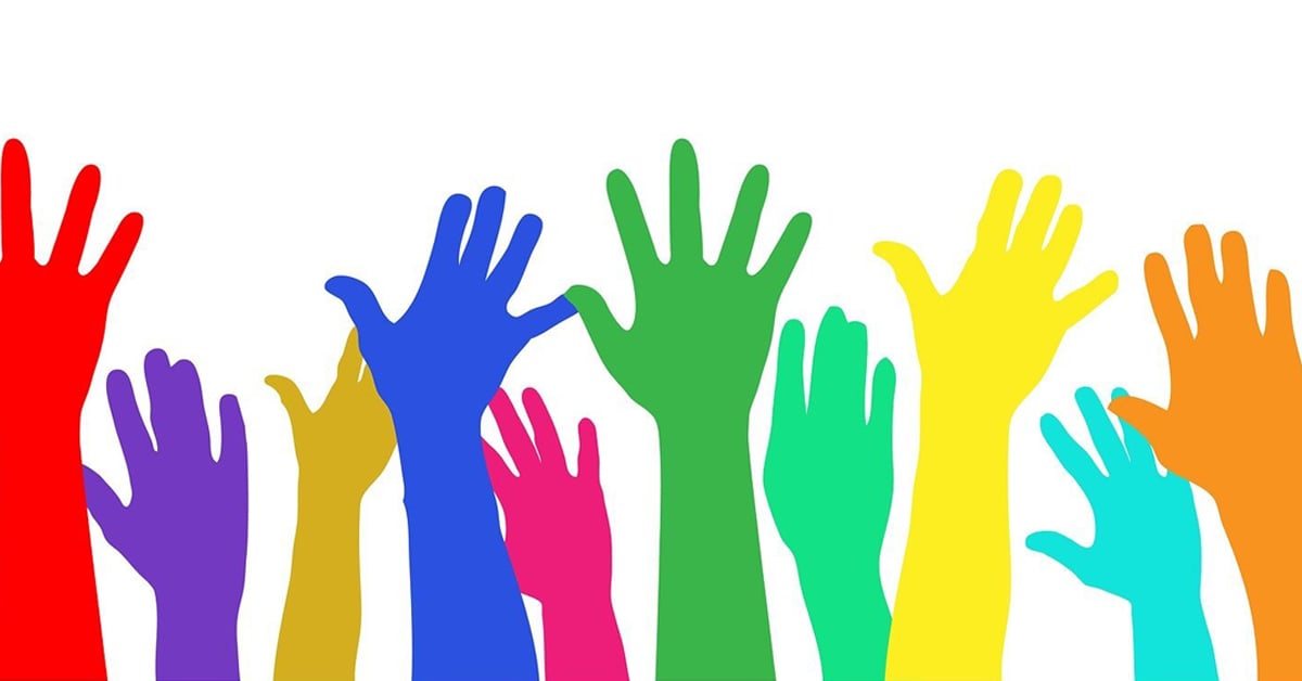 diverse colors of hands raised